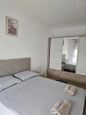 a bedroom with a large bed with towels on it at SOL Apartment in Ulcinj
