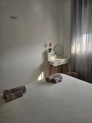 a bedroom with a bed with two towels on it at SOL Apartment in Ulcinj