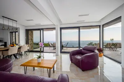 a living room with a purple couch and a table at Villa Mare in Petrovac na Moru
