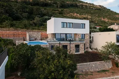 a house on a hill with a swimming pool at Villa Mare in Petrovac na Moru