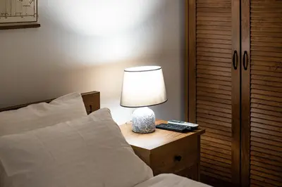 a bedroom with a bed and a lamp on a night stand at Dusan Residency in Kotor