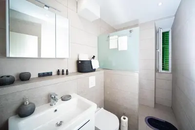 a bathroom with a sink and a toilet and a mirror at Dusan Residency in Kotor