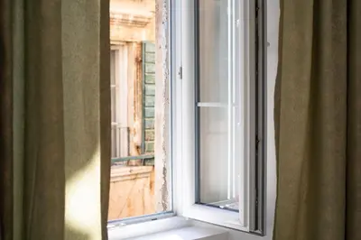 a window with a view of a balcony at Dusan Residency in Kotor
