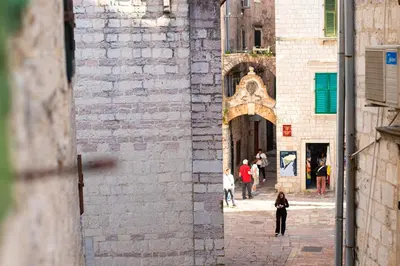 a group of people walking down a street at Dusan Residency in Kotor