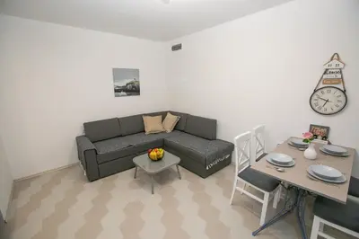 a living room with a couch and a table at Vila Varagic in Budva