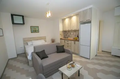 a living room with a couch and a bed at Vila Varagic in Budva