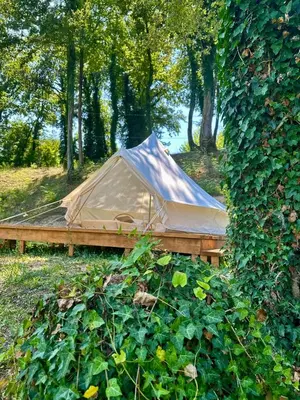 a tent on a wooden platform in a field at Zeta River Glamping in Danilovgrad