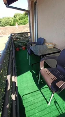 a patio with a table and chairs on a balcony at Urban Retreat Dalmatinska in Podgorica