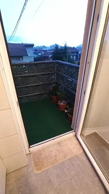 a view of a balcony with a green yard at Urban Retreat Dalmatinska in Podgorica