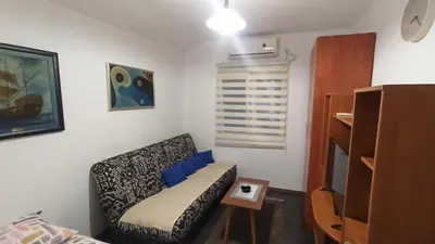 a living room with a couch and a table at Urban Retreat Dalmatinska in Podgorica