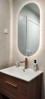 a bathroom with a sink and a mirror at Design Apartment with Panoramic Views in Podgorica