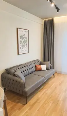 a living room with a couch in a room at Design Apartment with Panoramic Views in Podgorica