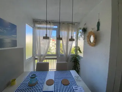 a dining room with a table and a window at Bar Centar Lux in Bar