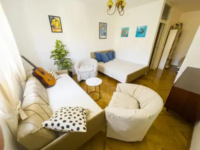 a living room with a couch and a guitar at Bar Centar Lux in Bar