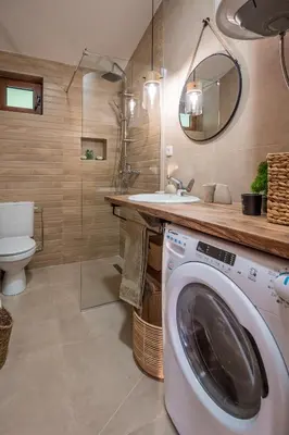 a bathroom with a washing machine and a sink at Case del Tramonto in Kotor