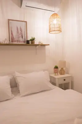 a bedroom with a white bed and a lamp at Case del Tramonto in Kotor