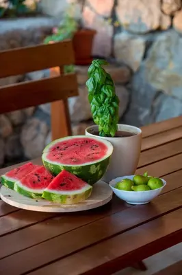 a table with a plate of watermelon sandwiches and a bowl of limes at Case del Tramonto in Kotor