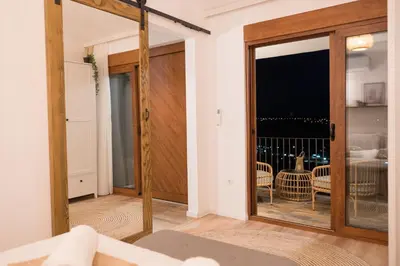 a room with a glass door with a view of the ocean at Case del Tramonto in Kotor