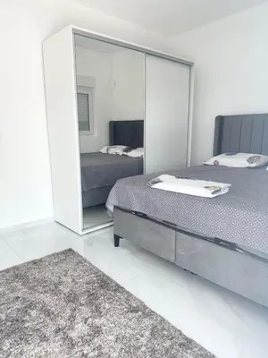 a bedroom with two beds and a large mirror at L U X V I L A, Dobre Vode in Dobra Voda