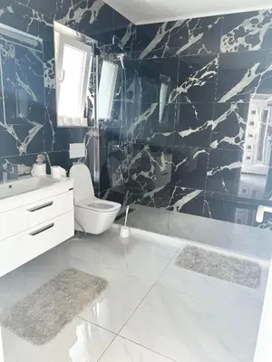 a bathroom with a toilet and a sink at L U X V I L A, Dobre Vode in Dobra Voda