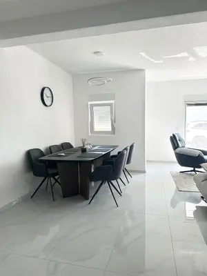 a dining room with a table and chairs at L U X V I L A, Dobre Vode in Dobra Voda