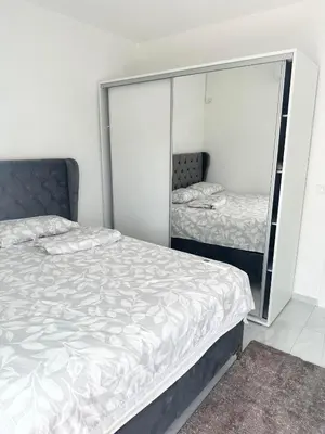 a bedroom with two beds and a mirror at L U X V I L A, Dobre Vode in Dobra Voda