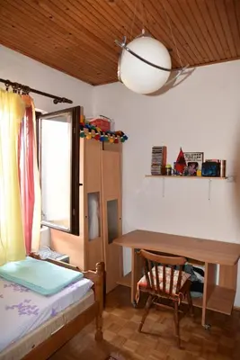 a bedroom with a desk and a bed and a table at Valdanos in Ulcinj