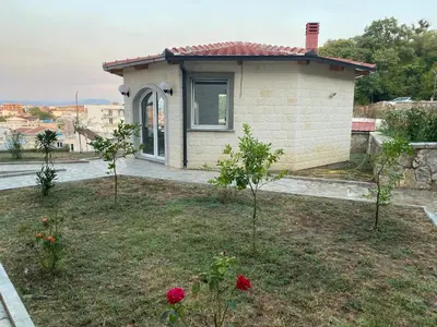 a small house with trees in front of it at Apartments Villa Bari in Ulcinj