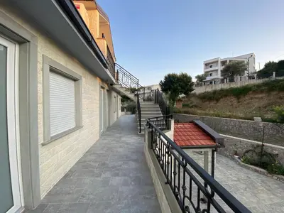 a balcony with a staircase next to a building at Apartments Villa Bari in Ulcinj