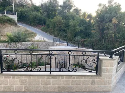 a balcony with a wrought iron railing next to a road at Apartments Villa Bari in Ulcinj