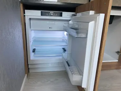 an empty refrigerator with its door open in a kitchen at Apartments Villa Bari in Ulcinj