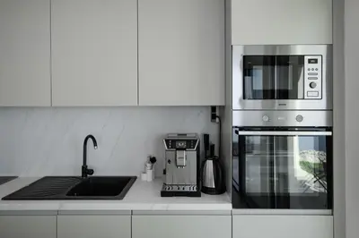 a kitchen with a microwave oven and a sink at Green Hills Villa in Bar