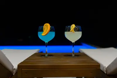 two glasses with an orange slice in them on a table at Green Hills Villa in Bar