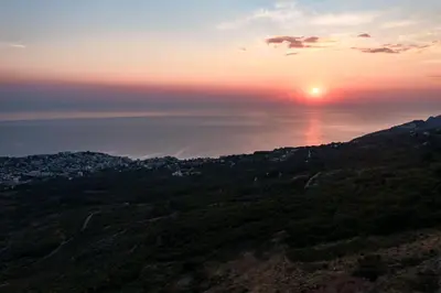 a sunset over the ocean with the sun in the sky at Green Hills Villa in Bar