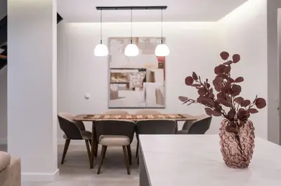 a dining room with a table and a vase with a plant at Green Hills Villa in Bar