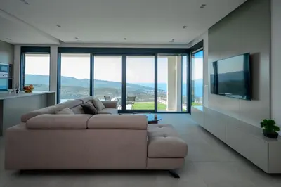 a living room with a couch and a flat screen tv at Green Hills Villa in Bar
