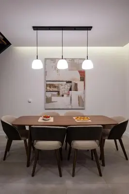 a dining room with a wooden table and chairs at Green Hills Villa in Bar