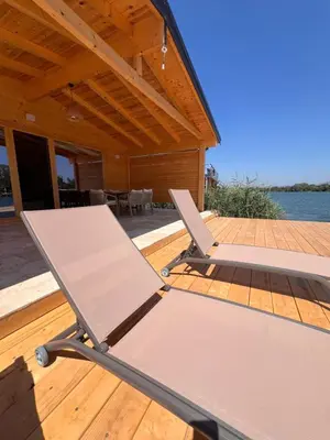 a couple of chairs sitting on a wooden deck at Gold fish3 in Ulcinj