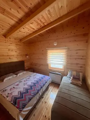 a bedroom with a bed in a log cabin at Gold fish3 in Ulcinj