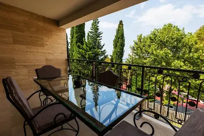 a balcony with a glass table and chairs at Luxury Apartments Przno in Budva