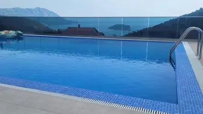 a blue swimming pool with a view of the mountains at Villa Moonlight in Budva