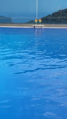 a large body of blue water with a pole in the background at Villa Moonlight in Budva