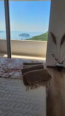 a bedroom with a bed with a view of the ocean at Villa Moonlight in Budva