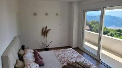 a bedroom with a bed and a large window at Villa Moonlight in Budva