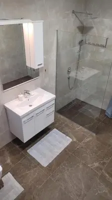 a bathroom with a white sink and a shower at Villa Moonlight in Budva
