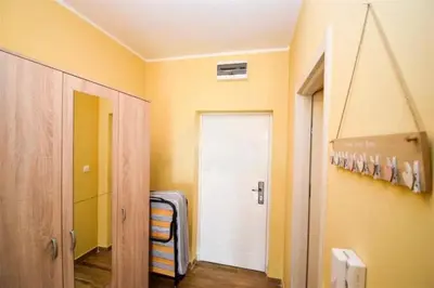 a hallway with a white door in a room at Charming studio in Podgorica