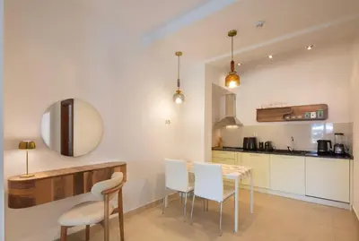 a kitchen and dining room with a table and chairs at Torch Apartments in Budva