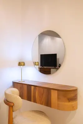 a mirror on a wall next to a desk with a television at Torch Apartments in Budva