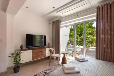 a living room with a tv and a large window at Torch Apartments in Budva