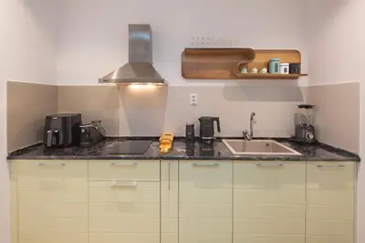 a kitchen with a sink and a counter top at Torch Apartments in Budva